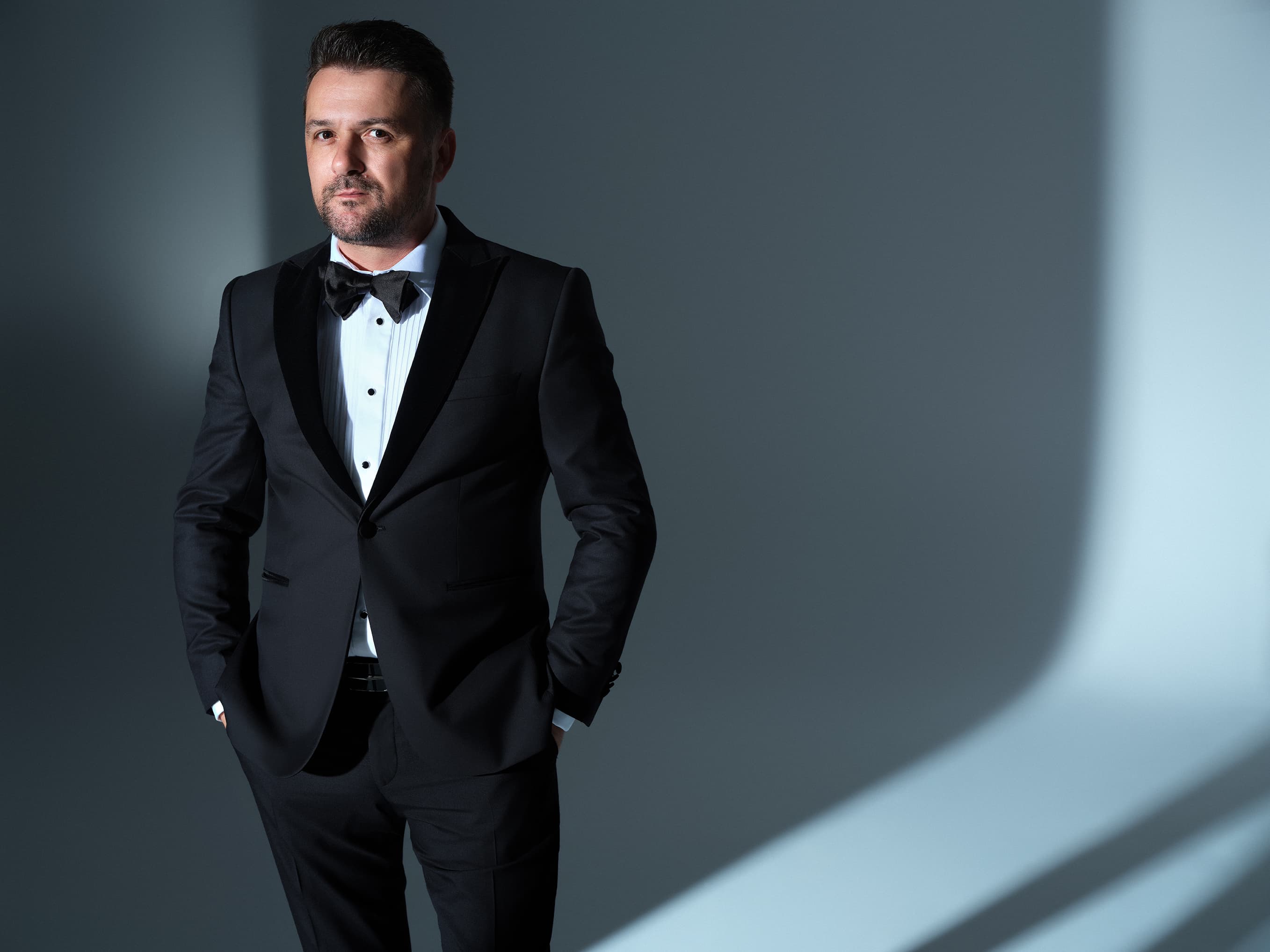 Radu Ionuț, vocea de bariton a SymphoNote, portret de studio în ținută neagră